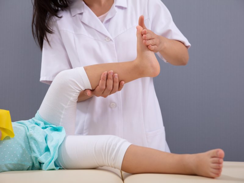Close up,Of,A,Female,Physiotherapist,Massaging,Patient,Girl's,Foot