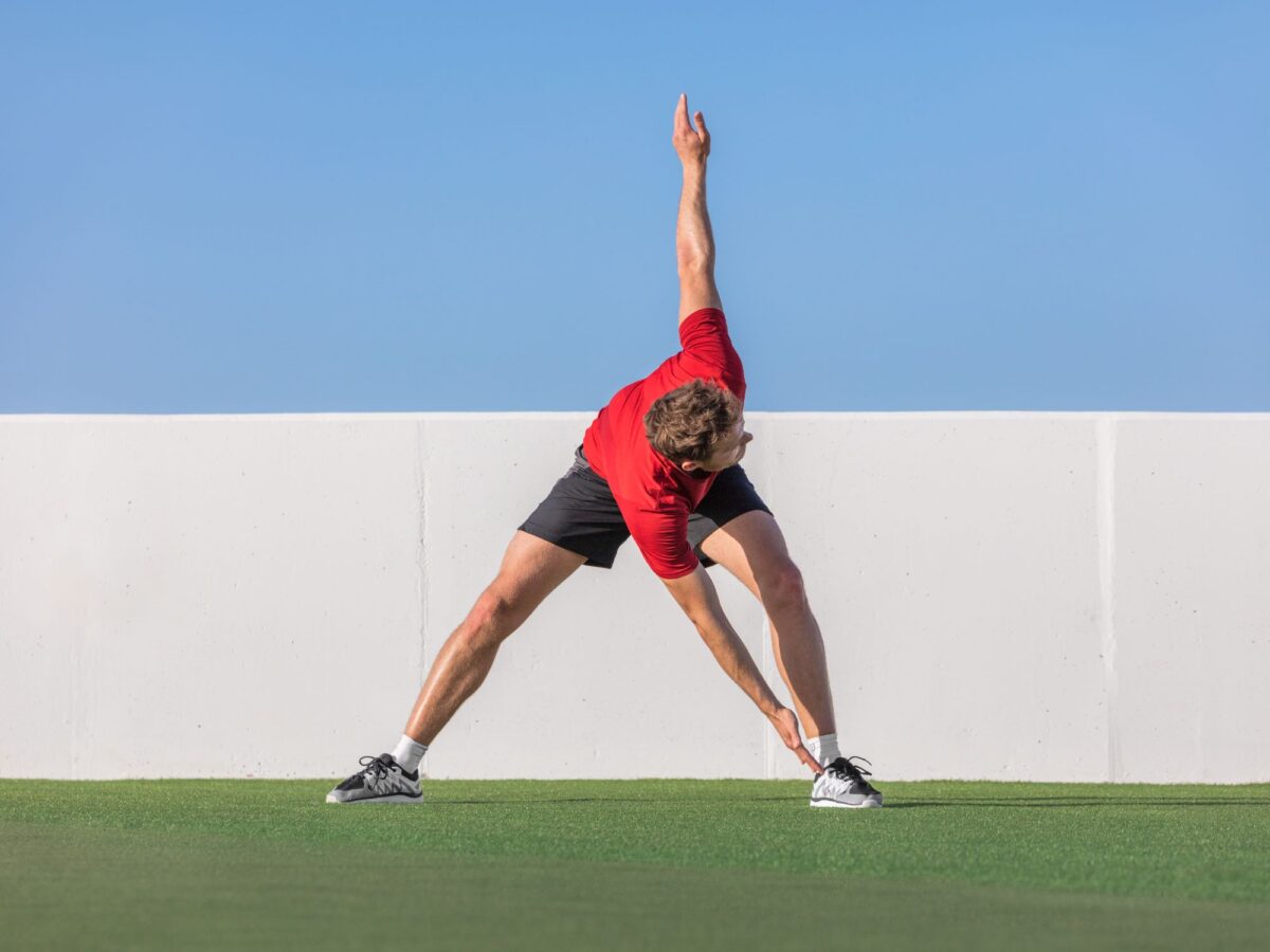 Man doing a dynamic stretch outside