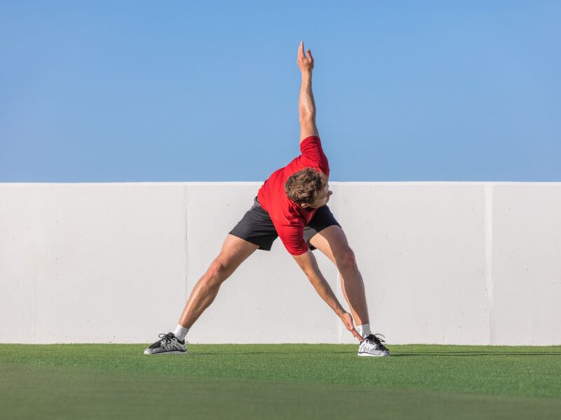 Man doing a dynamic stretch outside