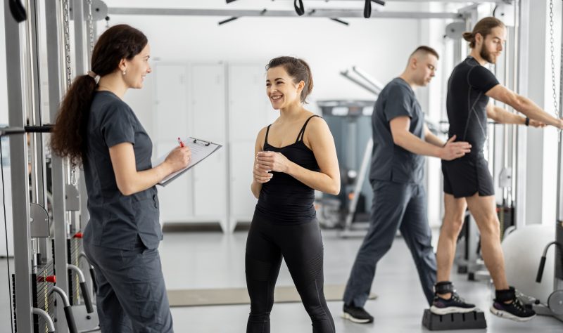 People,At,Rehabilitation,Center,,Woman,Talking,With,Female,Rehabilitologist,,Men