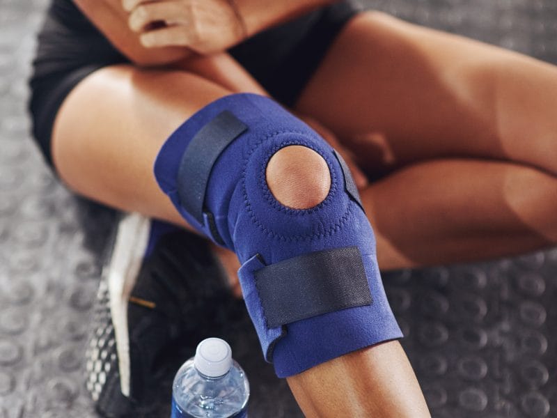 Dealing,With,Injury.,Shot,Of,A,Sportswoman,Wearing,A,Knee